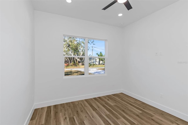 empty room with ceiling fan and hardwood / wood-style floors