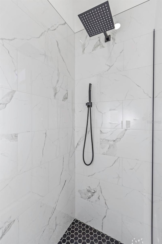 bathroom with tiled shower