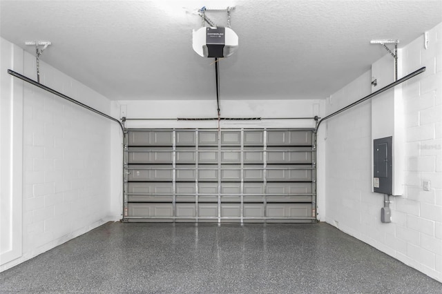 garage with a garage door opener and electric panel