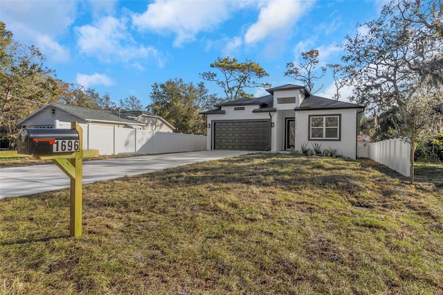 view of front facade featuring a front yard and a garage