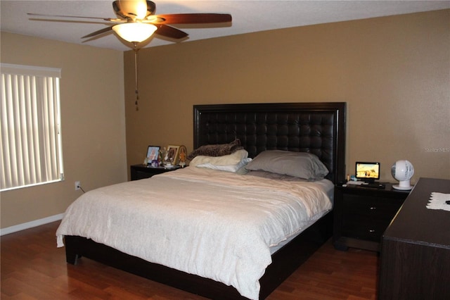 bedroom featuring ceiling fan and dark hardwood / wood-style floors