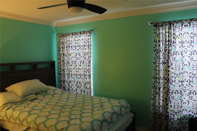 bedroom with ceiling fan and crown molding