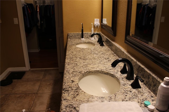 bathroom with tile patterned flooring and vanity