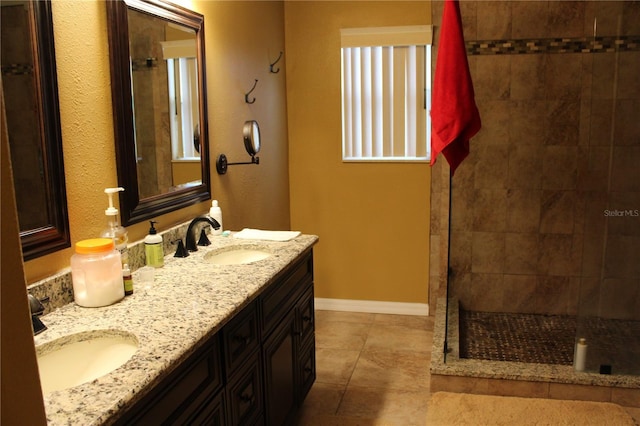 bathroom with vanity, tile patterned floors, and tiled shower