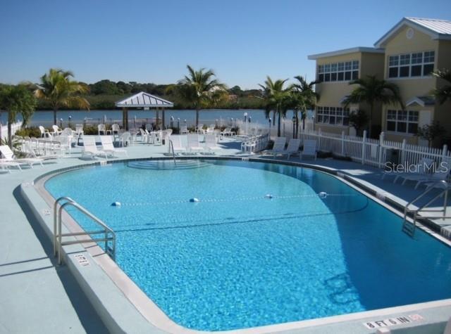 community pool featuring fence and a patio