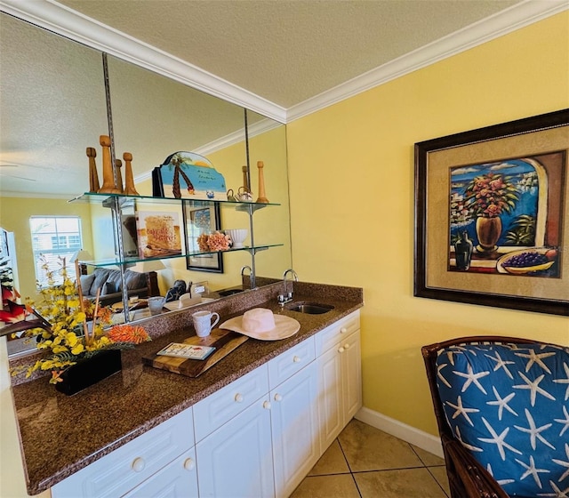 bathroom featuring crown molding, a textured ceiling, vanity, and tile patterned floors