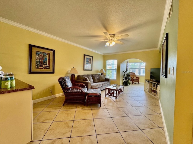 living area with arched walkways, light tile patterned flooring, and crown molding