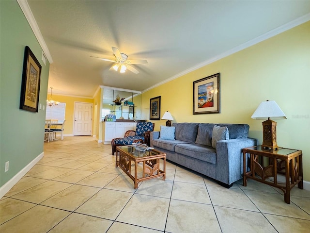 living room with light tile patterned flooring, crown molding, baseboards, and ceiling fan with notable chandelier