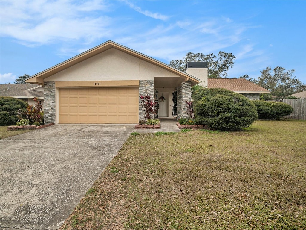 single story home with a front yard and a garage