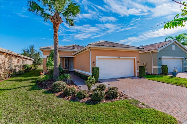 view of front of home with a garage and a front yard