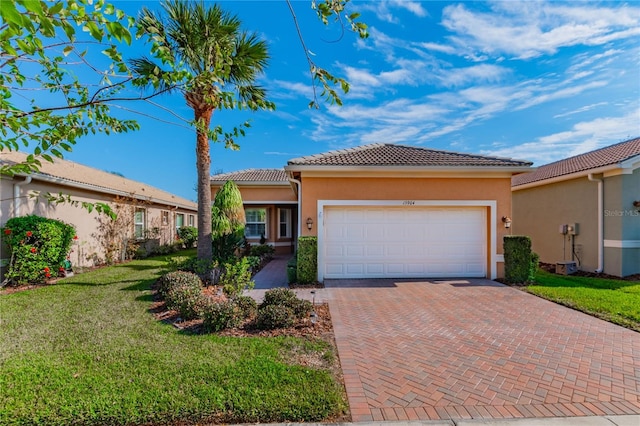 view of front of home featuring a garage and a front yard