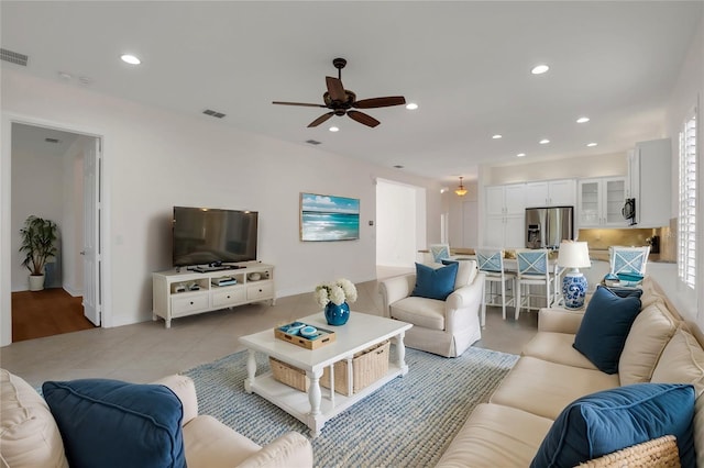 tiled living room featuring ceiling fan