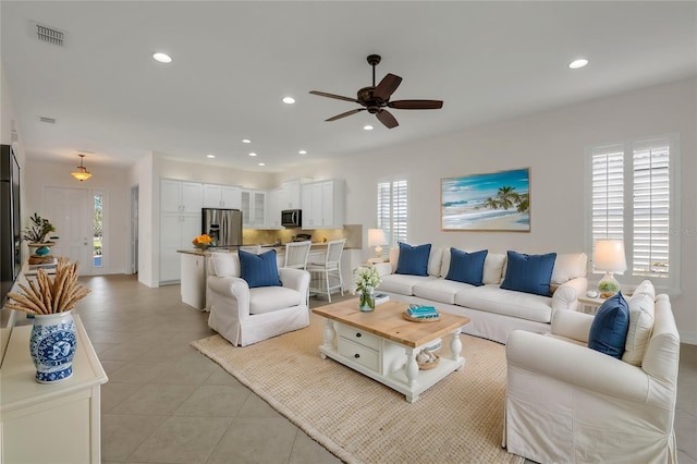 tiled living room featuring ceiling fan