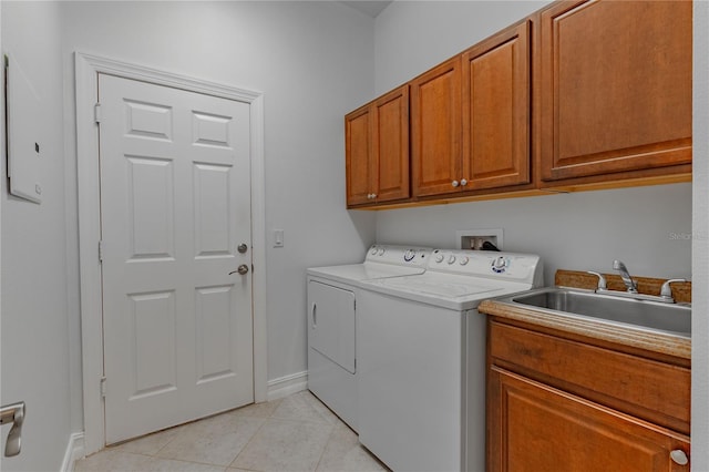 washroom featuring cabinets, sink, independent washer and dryer, and light tile patterned flooring