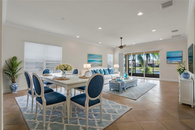 dining space with light tile patterned floors, crown molding, and ceiling fan