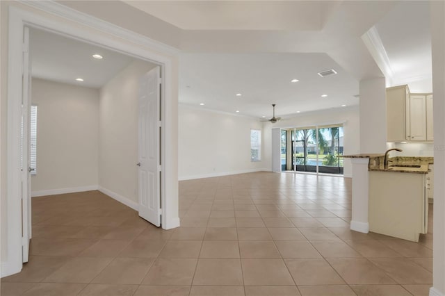 tiled empty room with sink, ornamental molding, and ceiling fan