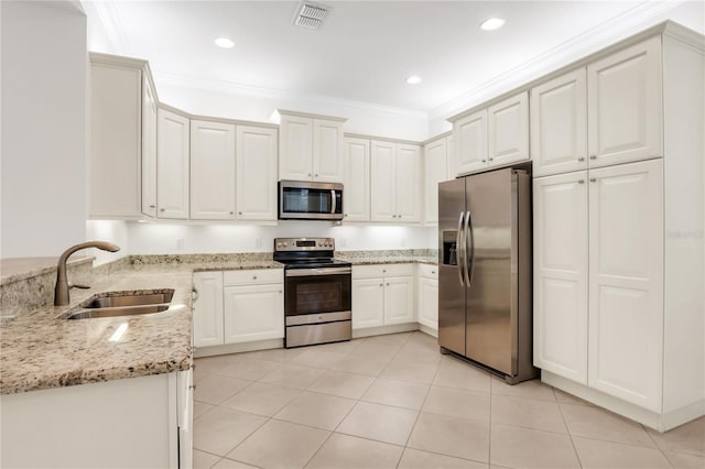 kitchen with sink, light stone counters, ornamental molding, appliances with stainless steel finishes, and white cabinets