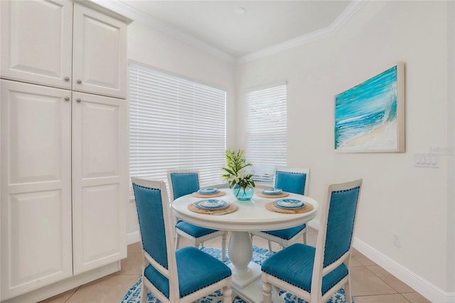 dining room featuring crown molding and light tile patterned floors