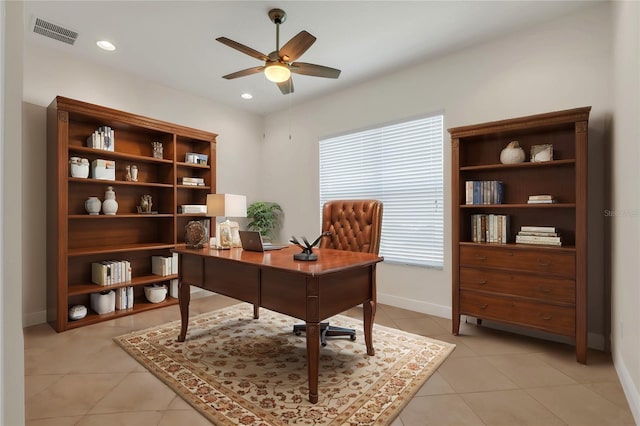 home office with light tile patterned floors and ceiling fan