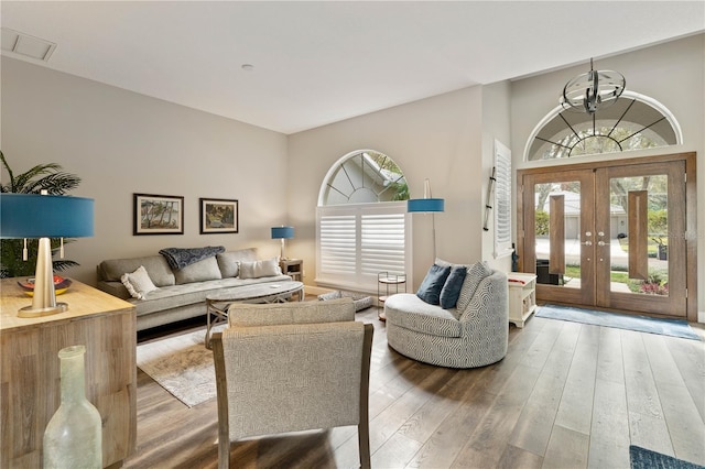 living room with french doors and hardwood / wood-style floors