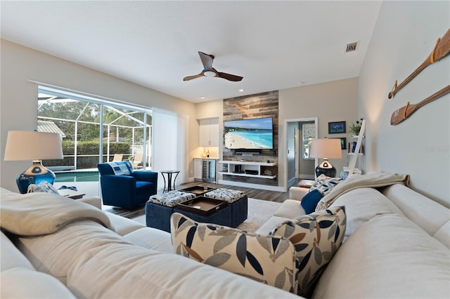 living room with hardwood / wood-style flooring and ceiling fan