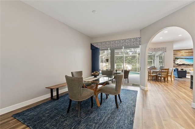 dining space with hardwood / wood-style flooring