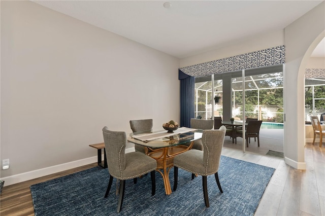 dining space with hardwood / wood-style floors