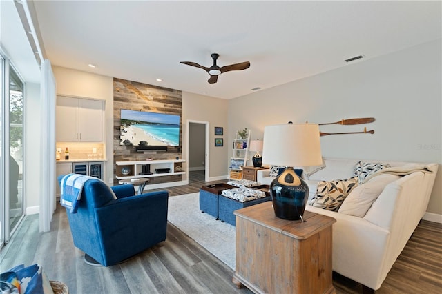 living room featuring ceiling fan and wood-type flooring