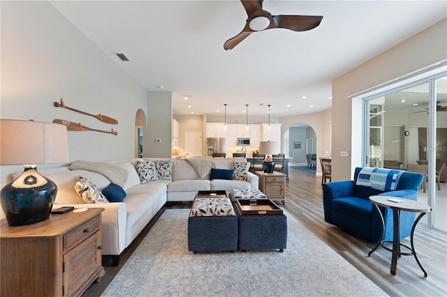 living room with ceiling fan and hardwood / wood-style floors