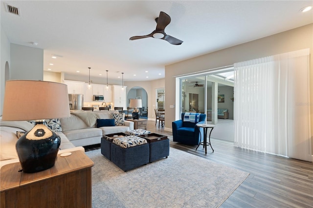 living room with hardwood / wood-style floors and ceiling fan