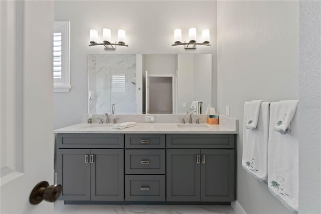 bathroom with a shower with door and vanity