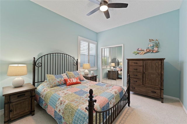 bedroom with light carpet and ceiling fan