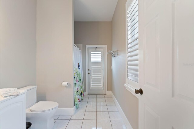 bathroom with tile patterned floors and toilet