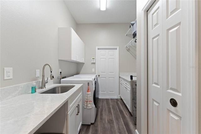 washroom with sink, separate washer and dryer, cabinets, and dark hardwood / wood-style floors