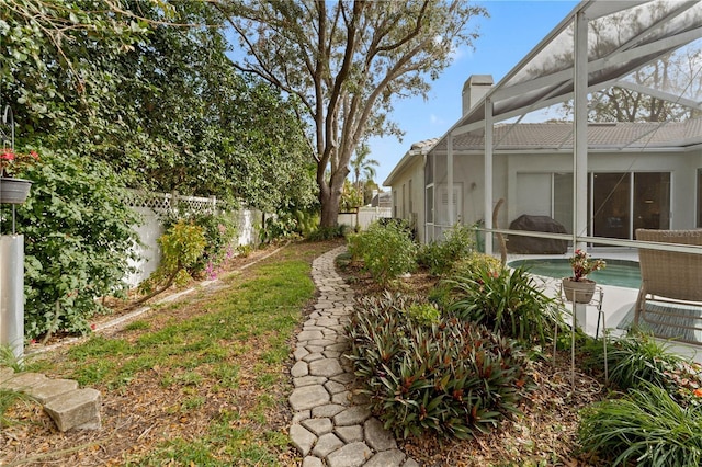 view of yard with a lanai and a fenced in pool