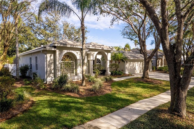 view of front of property with a front lawn and a garage