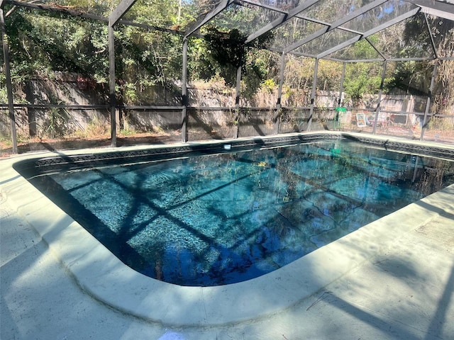 view of swimming pool with glass enclosure