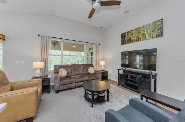 living room with hardwood / wood-style flooring, lofted ceiling, and ceiling fan