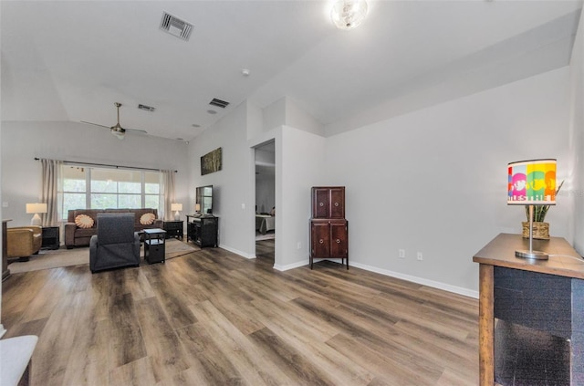 living room with lofted ceiling, hardwood / wood-style floors, and ceiling fan