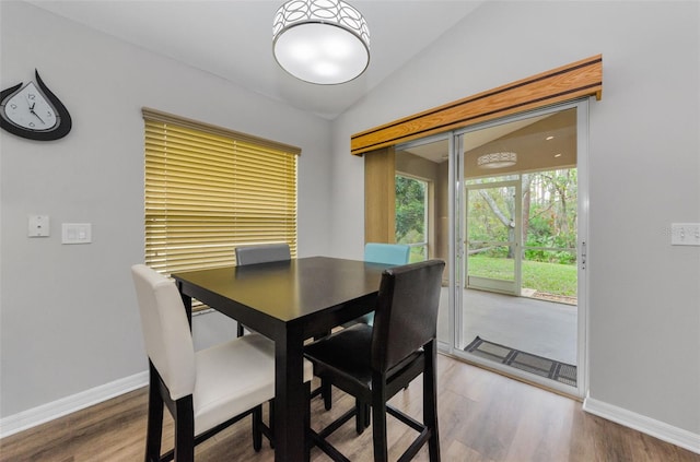 dining space with hardwood / wood-style flooring and lofted ceiling