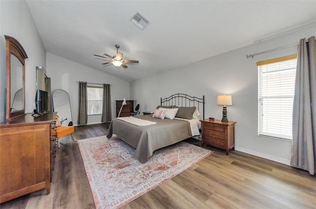 bedroom with dark wood-type flooring, ceiling fan, and vaulted ceiling