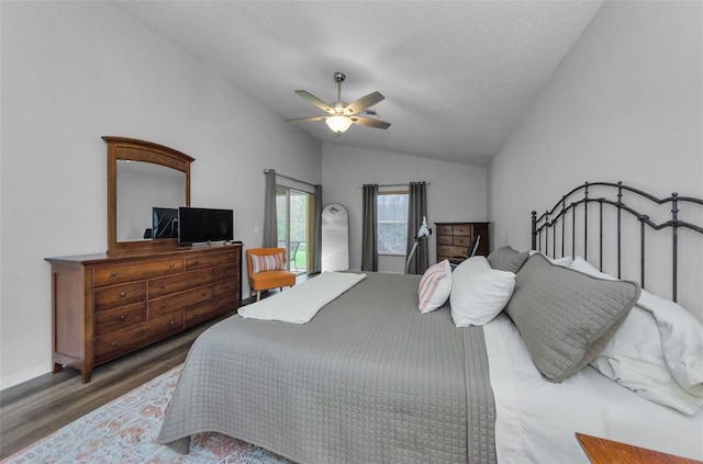 bedroom with dark wood-type flooring, ceiling fan, vaulted ceiling, and a textured ceiling