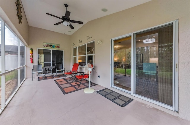 sunroom with ceiling fan and lofted ceiling