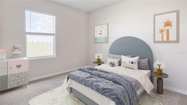 carpeted bedroom featuring multiple windows