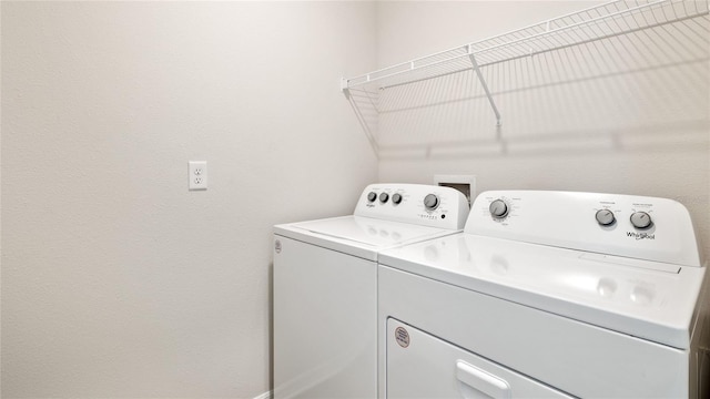 clothes washing area featuring independent washer and dryer