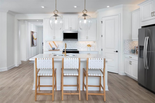 kitchen with white cabinets and stainless steel refrigerator with ice dispenser