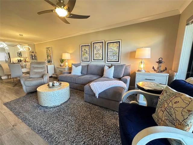 living room featuring ceiling fan, ornamental molding, and hardwood / wood-style flooring