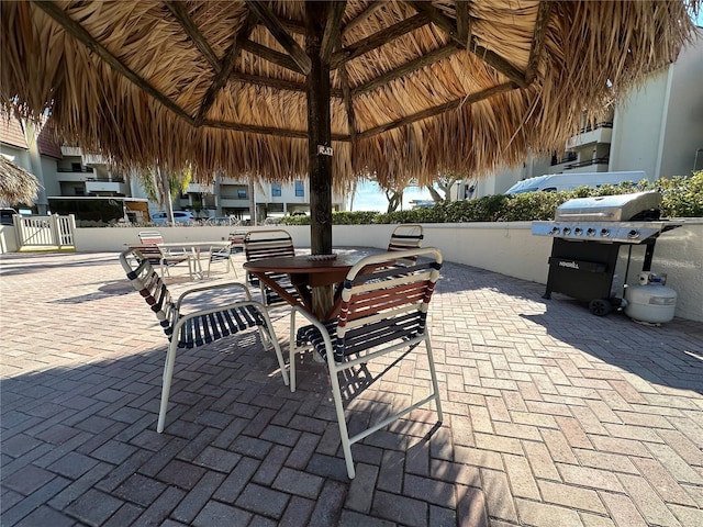 view of patio with area for grilling and a gazebo