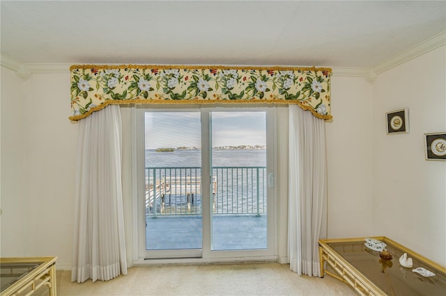 entryway with a water view, carpet flooring, and ornamental molding