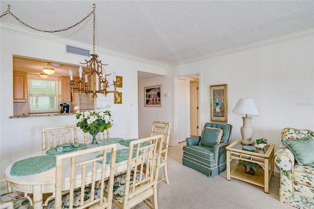 dining space featuring ornamental molding, light colored carpet, and an inviting chandelier